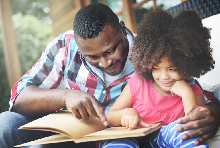 Father and daughter with book